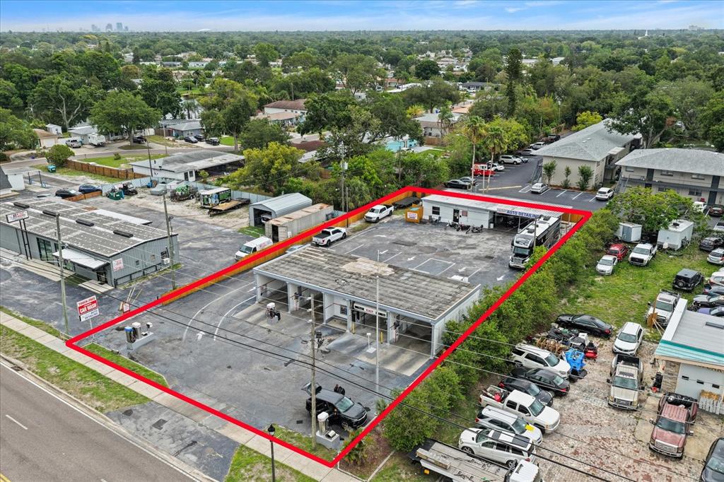 An aerial view shows a car wash facility with multiple bays and a parking lot — 6170 54TH AVENUE N, KENNETH CITY, FL