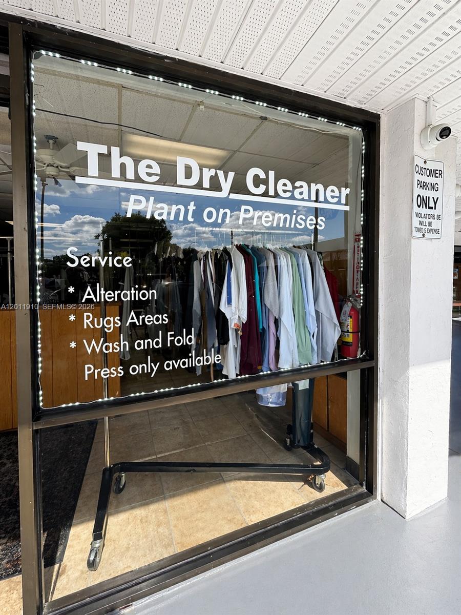 The exterior of a dry cleaner shop features a glass storefront with service information listed — 10114 S Military Trl, Boynton Beach FL 33436, BOYNTON BEACH, FL