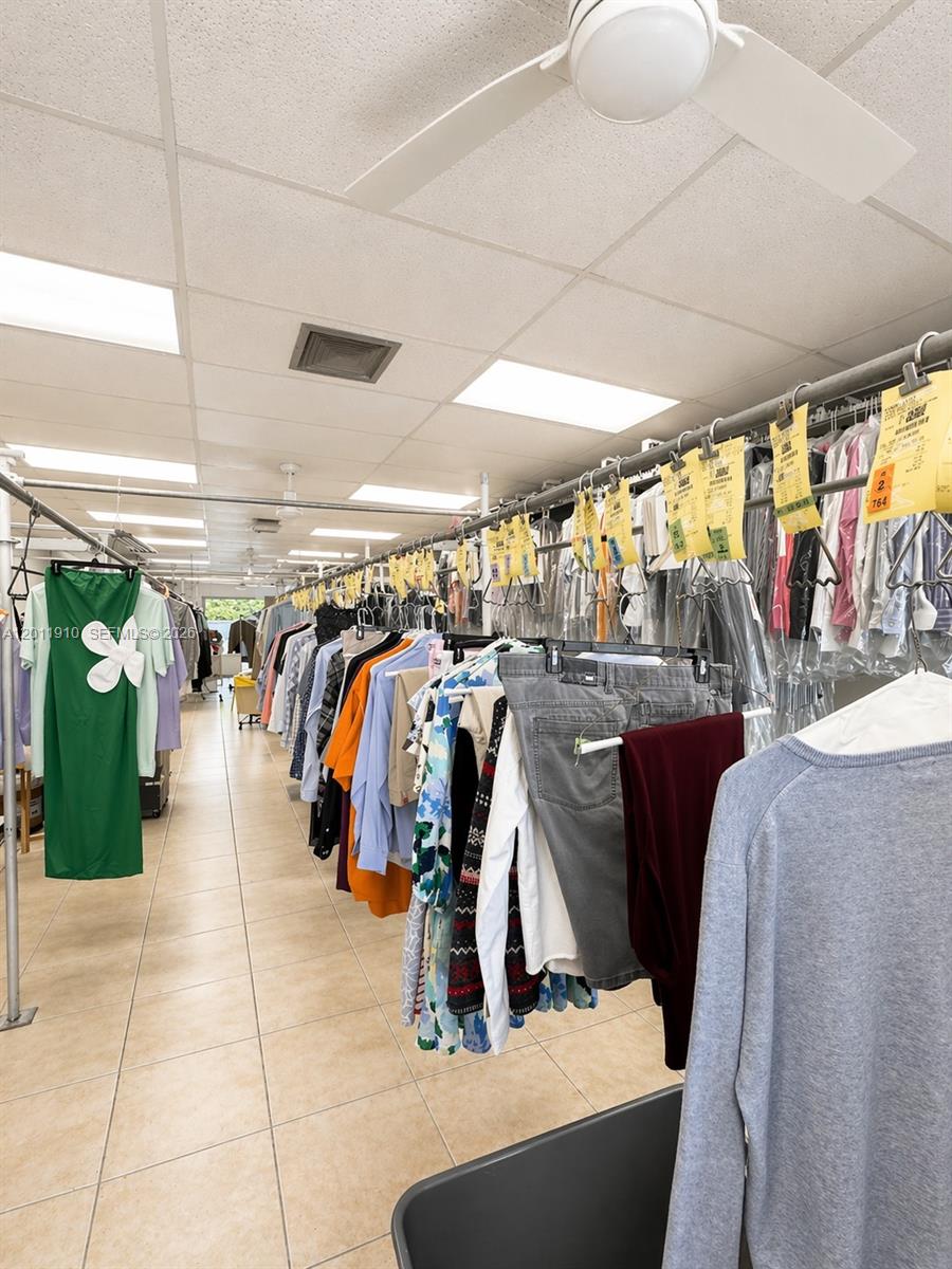 A commercial dry cleaning facility features rows of hanging garments on metal racks — 10114 S Military Trl, Boynton Beach FL 33436, BOYNTON BEACH, FL
