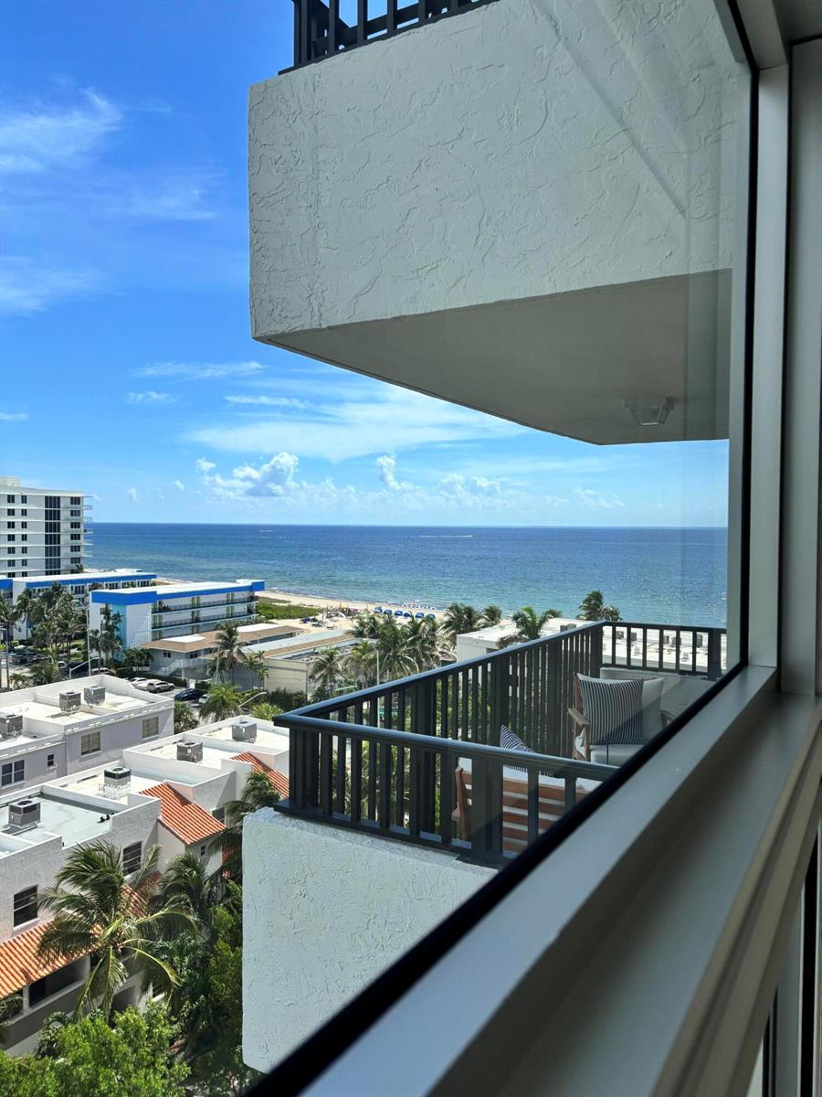 A view from a high-rise balcony overlooking a beach, ocean, and nearby residential buildings — 531 N Ocean Boulevard # 1107, Pompano Beach FL 33062, POMPANO BEACH, FL