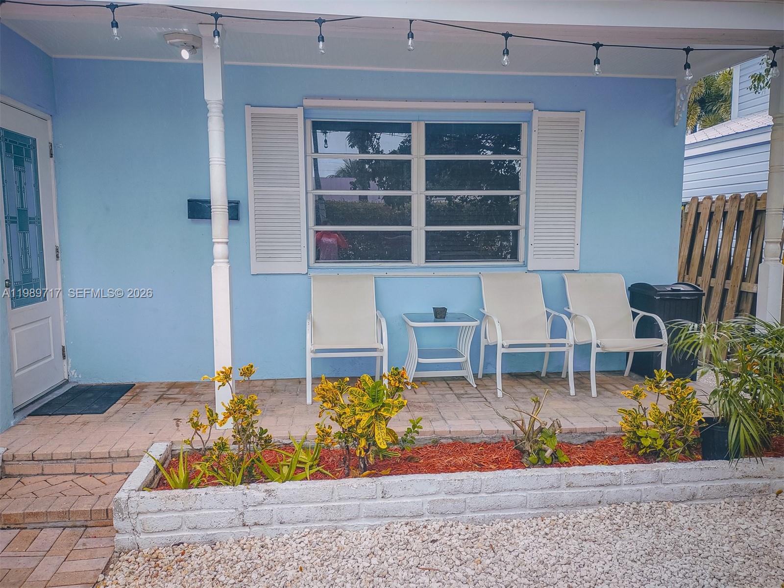A light blue house exterior features a front porch with three chairs and a planter — 2311 Patterson ave, Key West FL 33040, KEY WEST, FL
