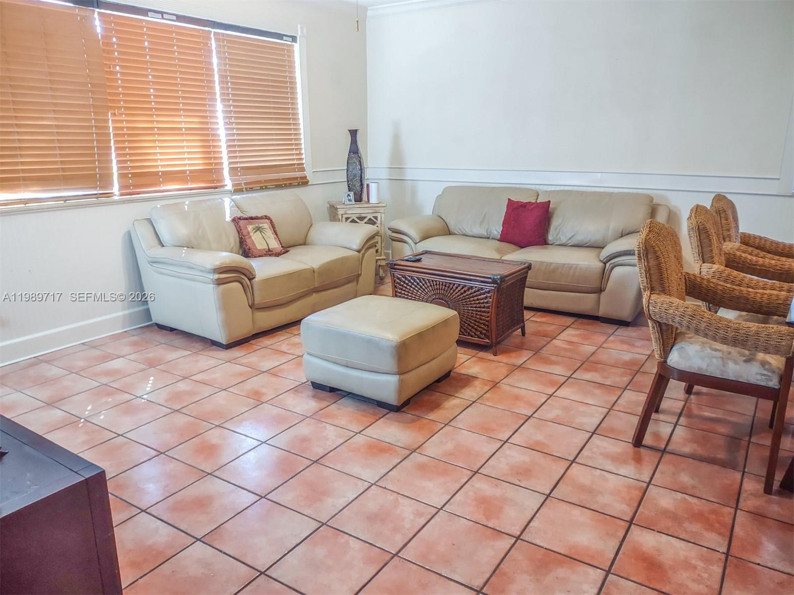 A living room features light-colored leather sofas, a wooden coffee table, and tiled flooring — 2311 Patterson ave, Key West FL 33040, KEY WEST, FL