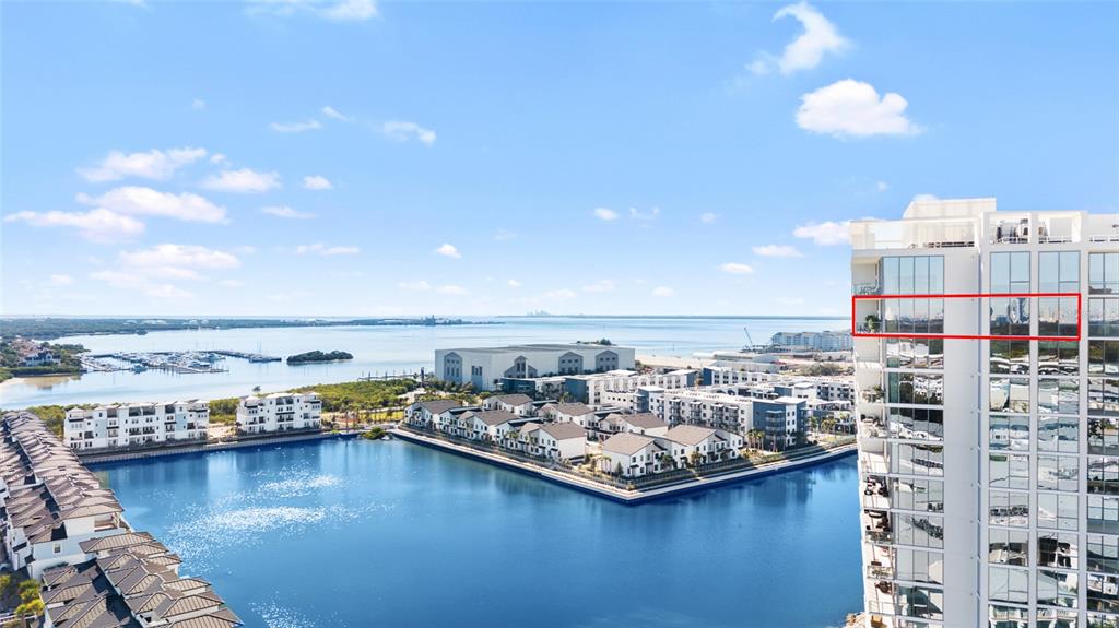 An aerial view shows a high-rise building with a balcony highlighted in red — 5120 MARINA WAY UNIT 16005, TAMPA, FL