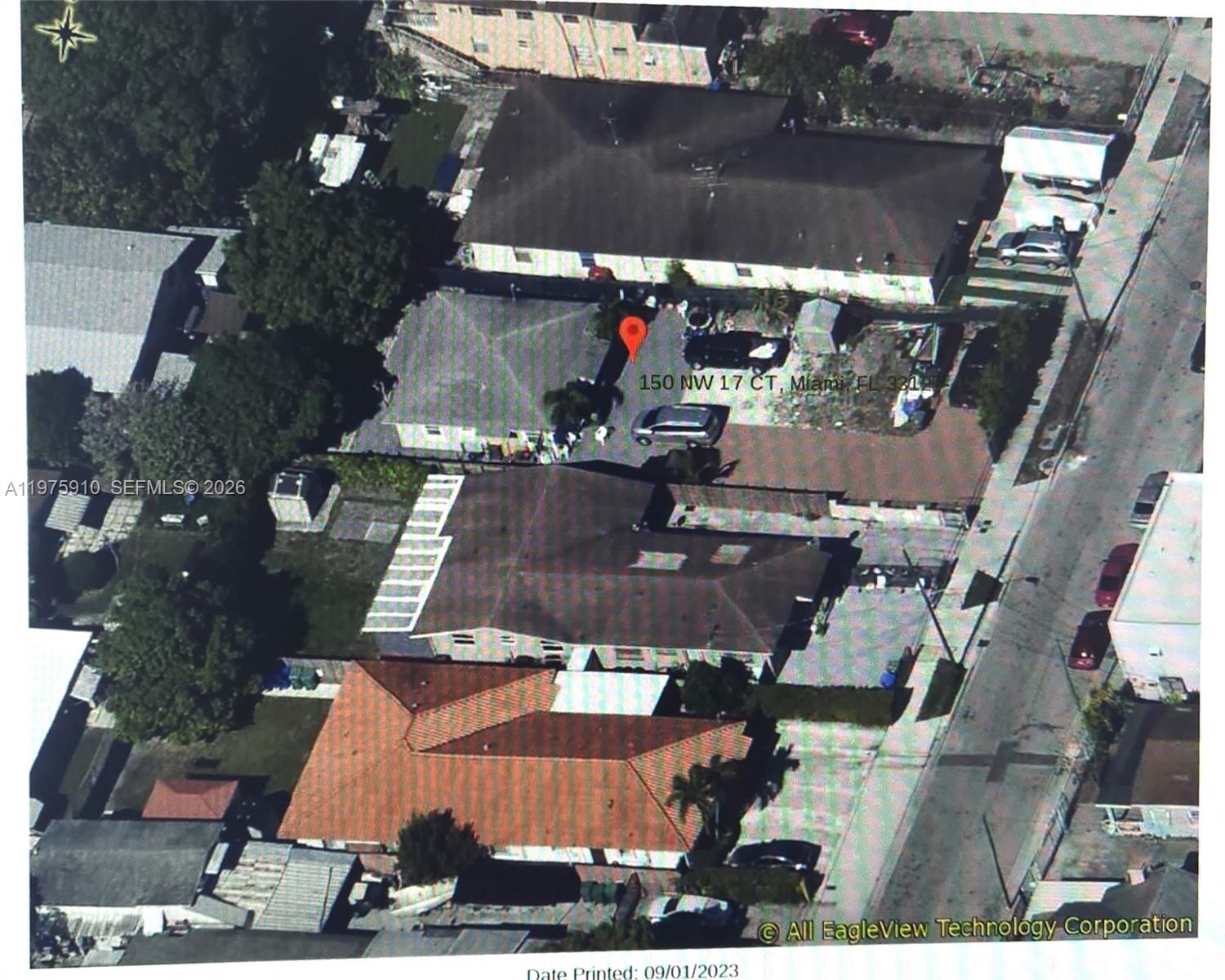 An aerial view shows several residential houses with paved driveways and surrounding trees — 150 NW 17th Ct, Miami FL 33125, MIAMI, FL