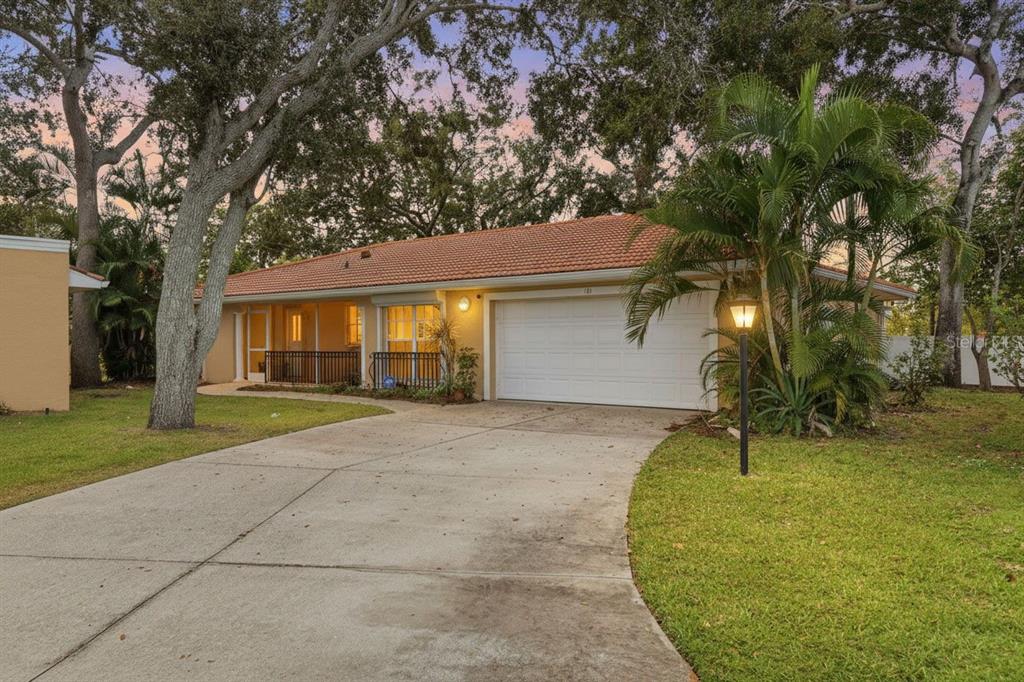 A single-story house with a tiled roof, a two-car garage, and a paved driveway — 131 49TH COURT E, PALMETTO, FL