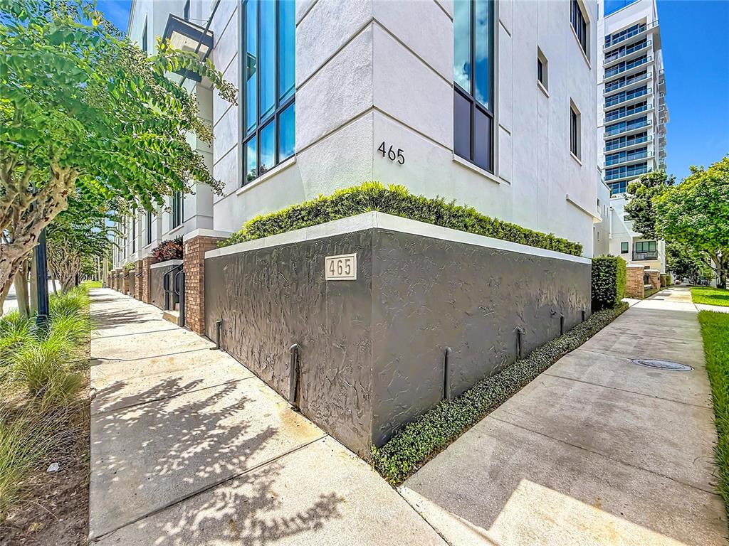 The exterior of a modern white building features a dark stucco base and address numbers — 465 E SOUTH STREET UNIT 6, ORLANDO, FL