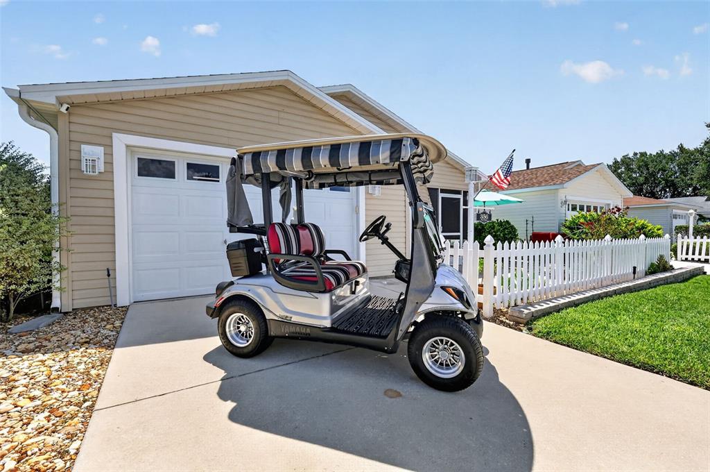 A silver Yamaha golf cart sits on a concrete driveway in front of a house — 356 KATHERINE PLACE, THE VILLAGES, FL