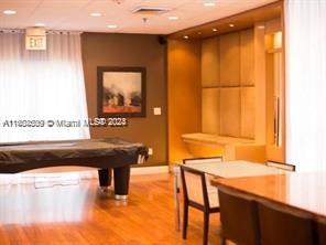 A room features a pool table, a dining table with chairs, and wood-paneled wall accents — 800 N Miami Ave # 1501, Miami FL 33130, MIAMI, FL