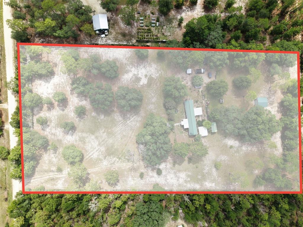 An aerial view shows a rectangular property lot outlined in red containing a house and trees — 12750 NE 65TH STREET, WILLISTON, FL