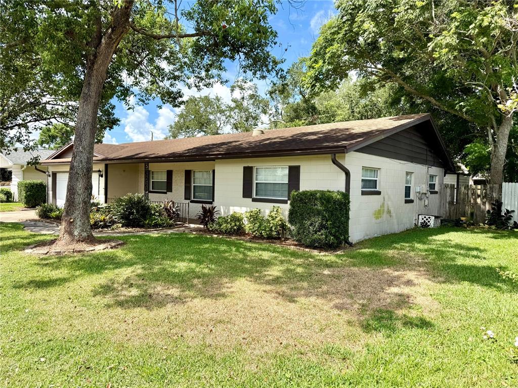 A single-story house with a white block exterior, brown roof, and a front lawn — 4332 BLONIGEN AVENUE, ORLANDO, FL