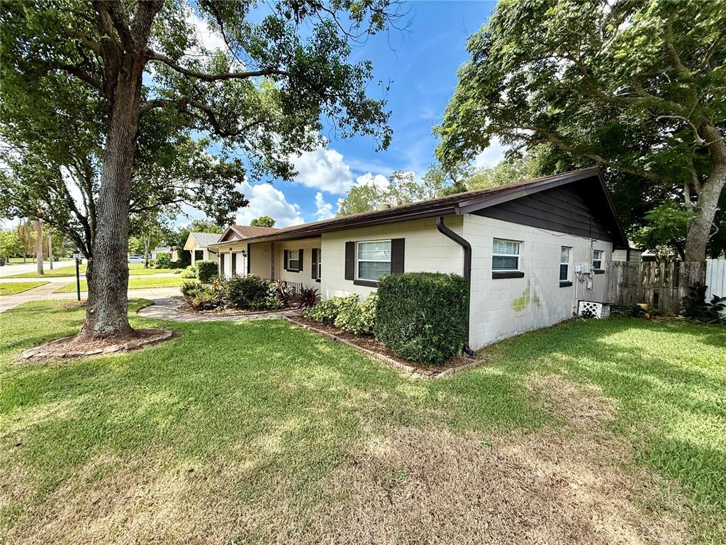 A single-story house with a concrete block exterior and a brown roof sits on grass — 4332 BLONIGEN AVENUE, ORLANDO, FL