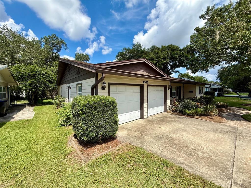 A single-story house with a two-car garage, a concrete driveway, and a manicured front lawn — 4332 BLONIGEN AVENUE, ORLANDO, FL