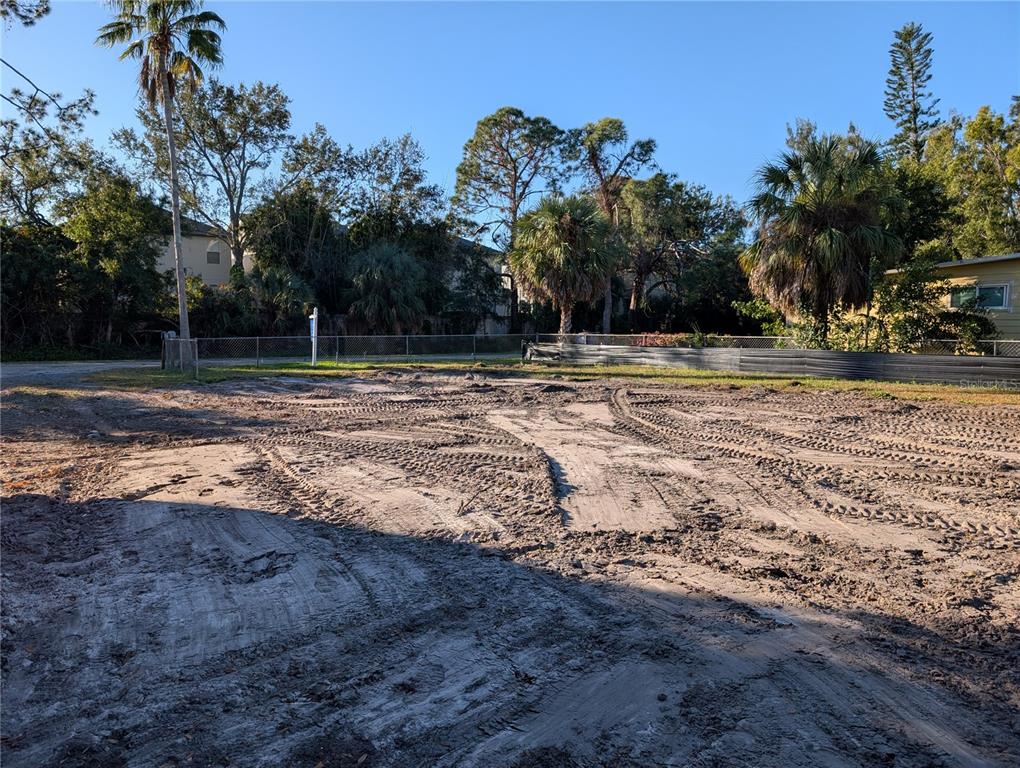 A vacant, cleared lot with tire tracks in the dirt and surrounding palm trees — 1331 MENTONE DRIVE NE, ST PETERSBURG, FL