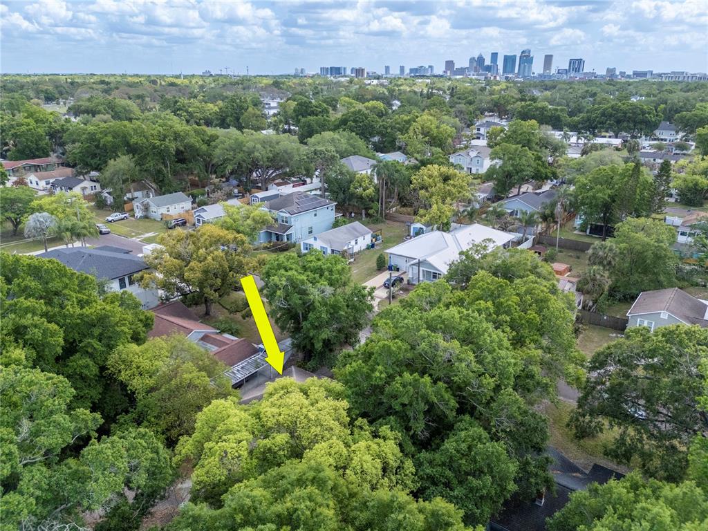 An aerial view shows a residential neighborhood with a yellow arrow pointing to a house — 817 W OHIO AVENUE, TAMPA, FL