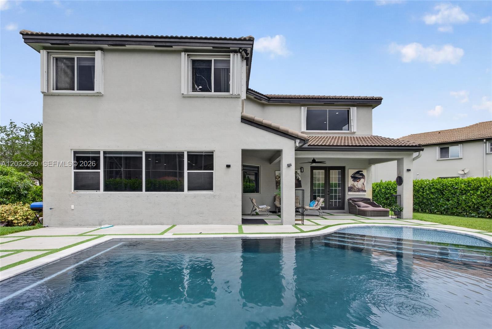 The exterior of a two-story house features a swimming pool and a covered patio area — 2167 SW 176th Ter, Miramar FL 33029, MIRAMAR, FL