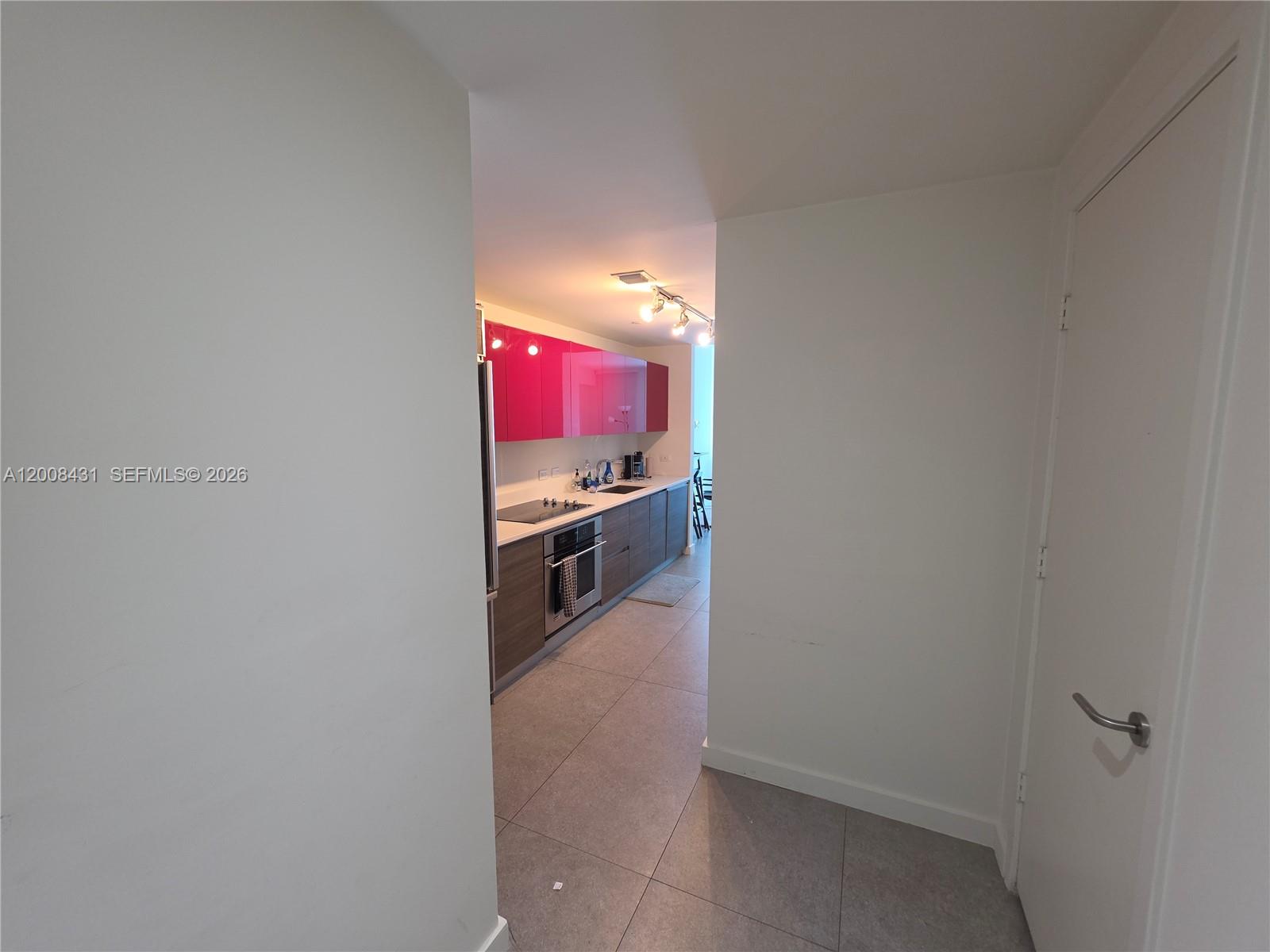 A bedroom with a bed, sofa, and floor-to-ceiling windows overlooking a neighboring high-rise building — 1100 S Miami Ave # 3705, Miami FL 33130, MIAMI, FL