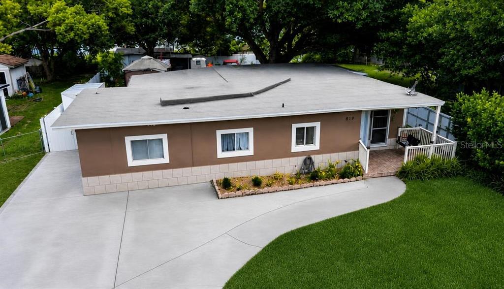 An aerial view of a single-story house with a brown exterior and a concrete driveway — 819 SAN JUAN BOULEVARD, ORLANDO, FL