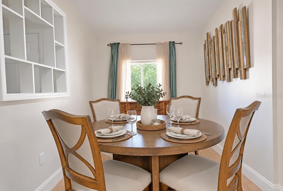 A dining room features a round wooden table with four chairs and wall-mounted shelving — 819 SAN JUAN BOULEVARD, ORLANDO, FL