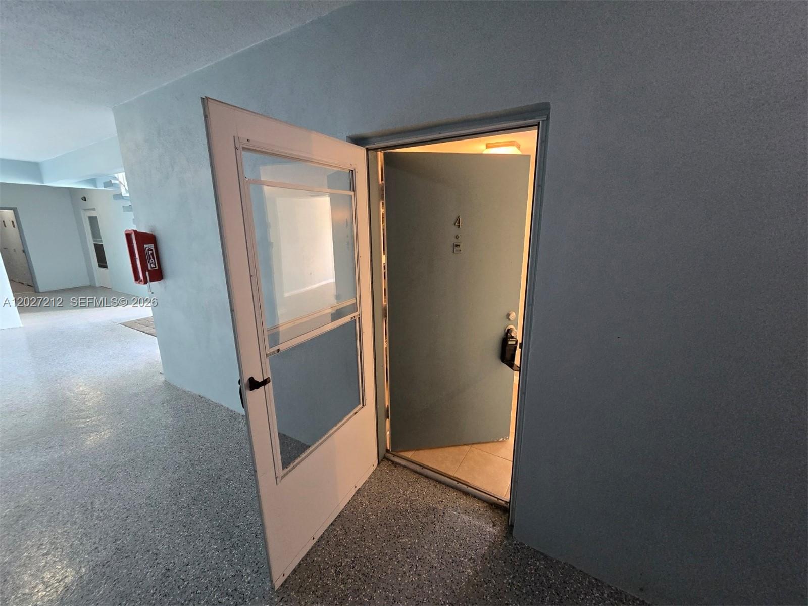 An open door with a screen door leads into a unit marked with number four — 950 S Kanner Hwy # 4, Stuart FL 34994, STUART, FL