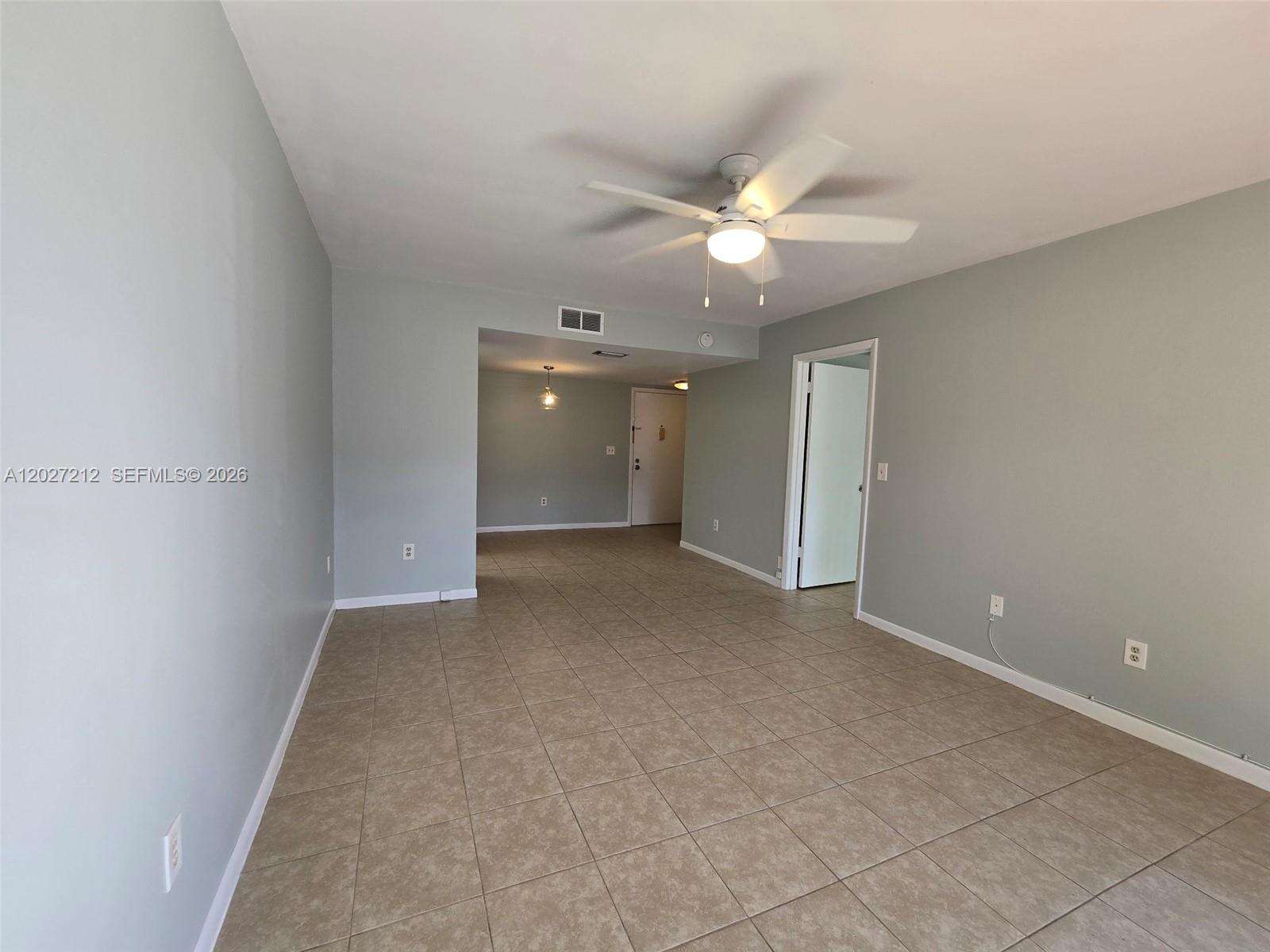 An empty room with light gray walls, beige tile flooring, and a ceiling fan — 950 S Kanner Hwy # 4, Stuart FL 34994, STUART, FL
