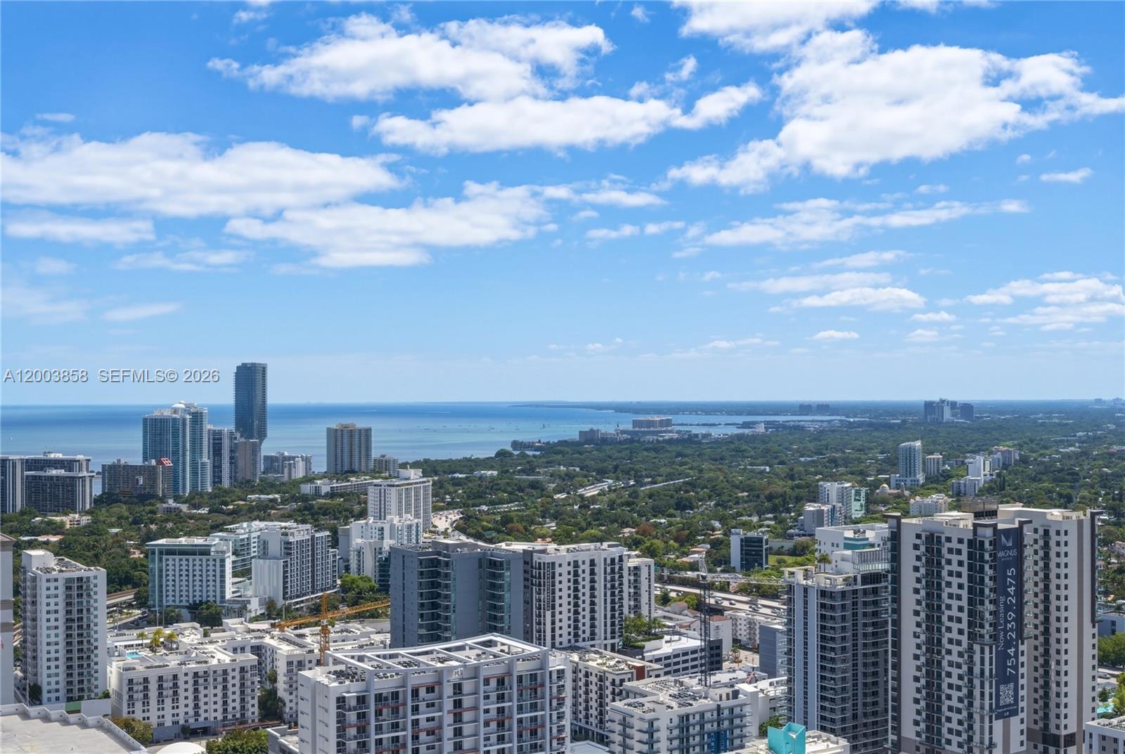 An elevated view shows a dense urban skyline overlooking a bay under a blue sky — 88 SW 7th St # 3710, Miami FL 33130, MIAMI, FL