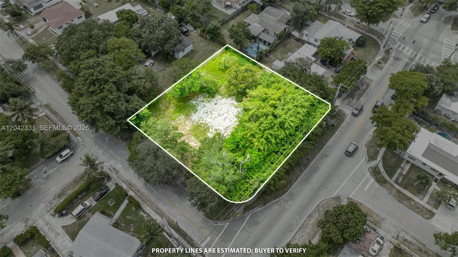An aerial view shows a vacant, tree-covered lot outlined in white on a corner street — 1585 NE 158th St, North Miami Beach FL 33162, NORTH MIAMI BEACH, FL