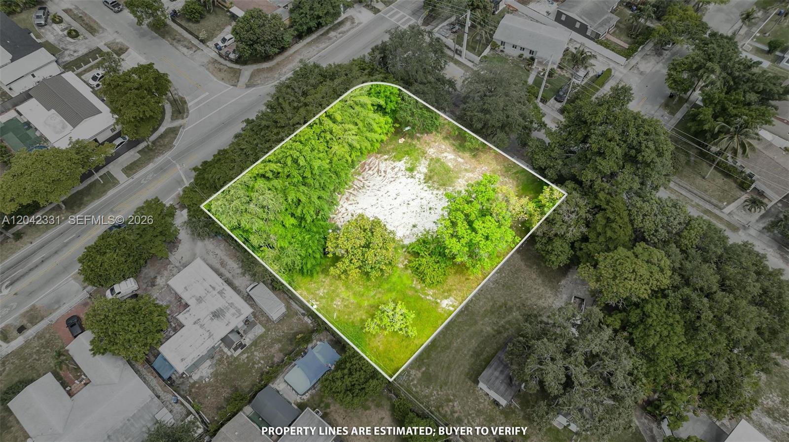 An aerial view shows a vacant, tree-lined rectangular lot surrounded by residential streets and houses — 1585 NE 158th St, North Miami Beach FL 33162, NORTH MIAMI BEACH, FL