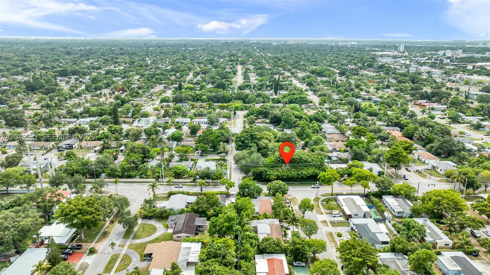 An aerial view shows a residential neighborhood with a red location pin over a property — 1585 NE 158th St, North Miami Beach FL 33162, NORTH MIAMI BEACH, FL