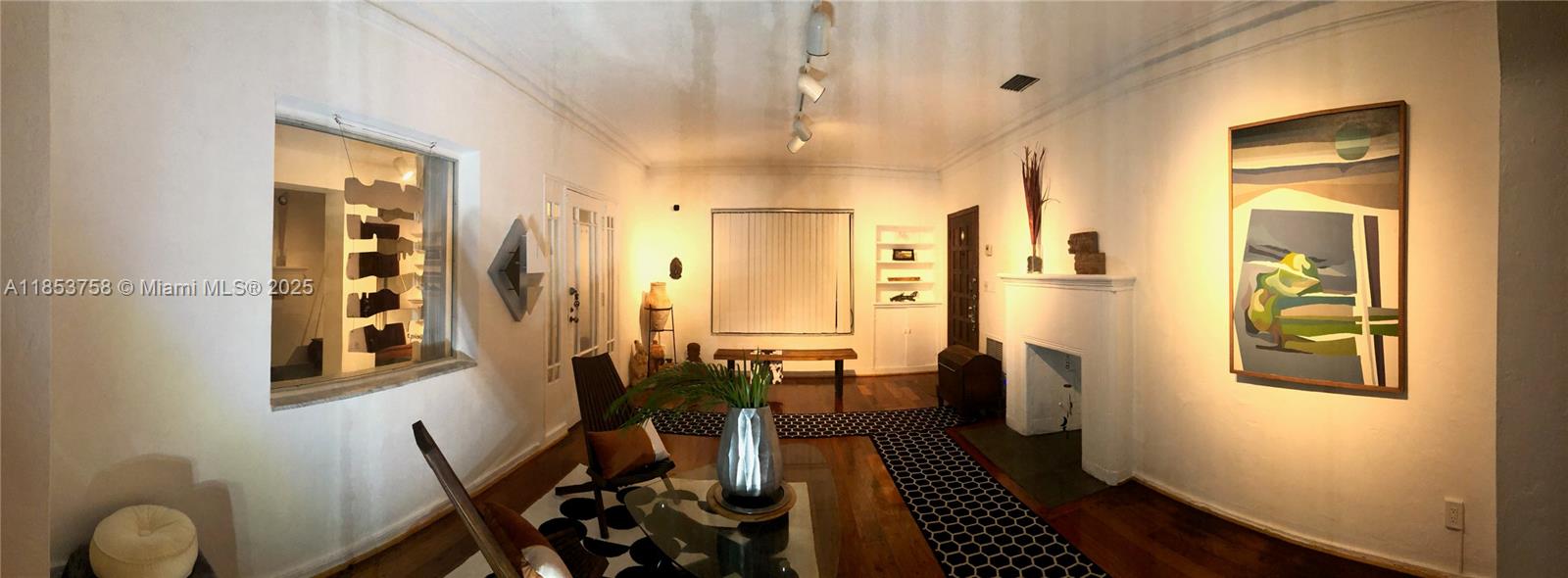 A living room features hardwood floors, a fireplace, and a large abstract painting on the wall — 1619 SW 13th St, Miami FL 33145, MIAMI, FL