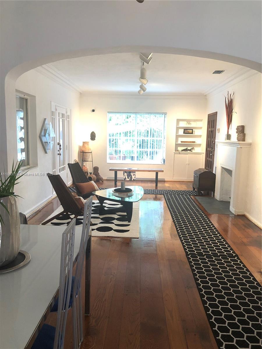 A living room with hardwood floors, a fireplace, and a black and white patterned rug — 1619 SW 13th St, Miami FL 33145, MIAMI, FL