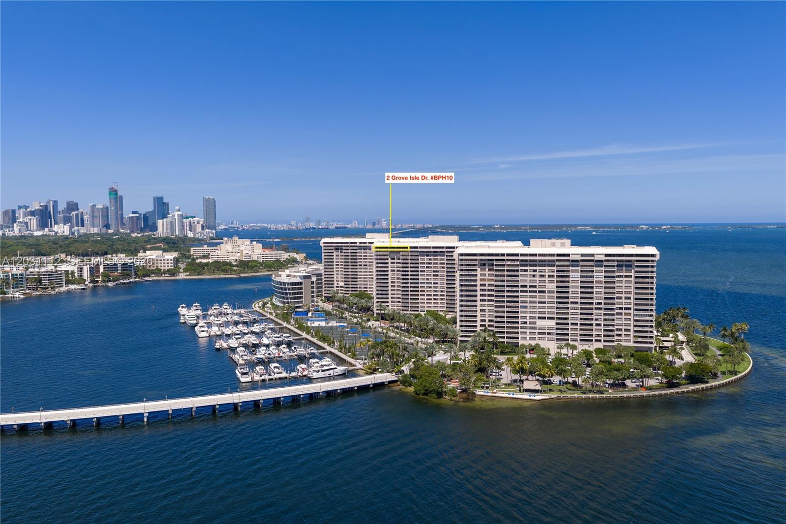 An aerial view shows a large residential complex on an island with a private marina — 2 Grove Isle Dr, Miami FL 33133, MIAMI, FL