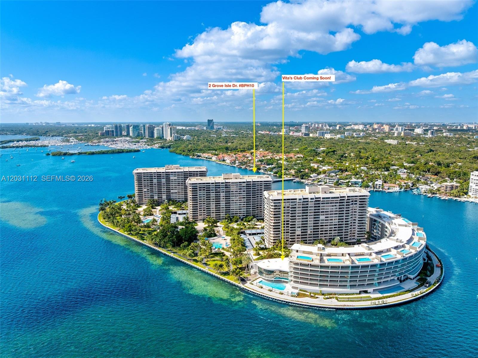An aerial view shows several large residential buildings situated on a private island surrounded by water — 2 Grove Isle Dr, Miami FL 33133, MIAMI, FL