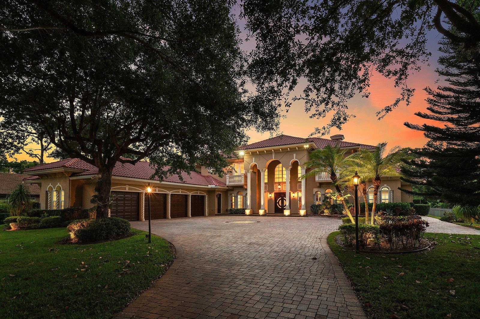 A large two-story Mediterranean-style house with a tiled roof and a paved circular driveway — 6071 NW 69th Way, Parkland FL 33067, PARKLAND, FL