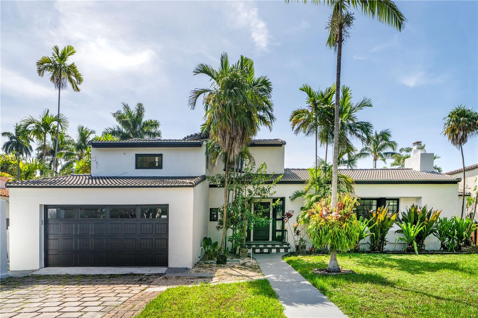 A two-story white house with a dark garage door and palm trees in the front yard — 5149 Alton Rd, Miami Beach FL 33140, MIAMI BEACH, FL