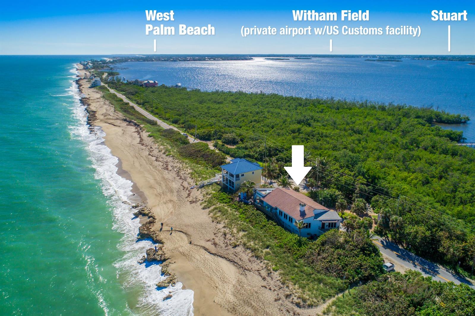 An aerial view of a coastal house situated between the ocean and a large bay — 23 NE Macarthur Boulevard, Stuart FL 34996, STUART, FL