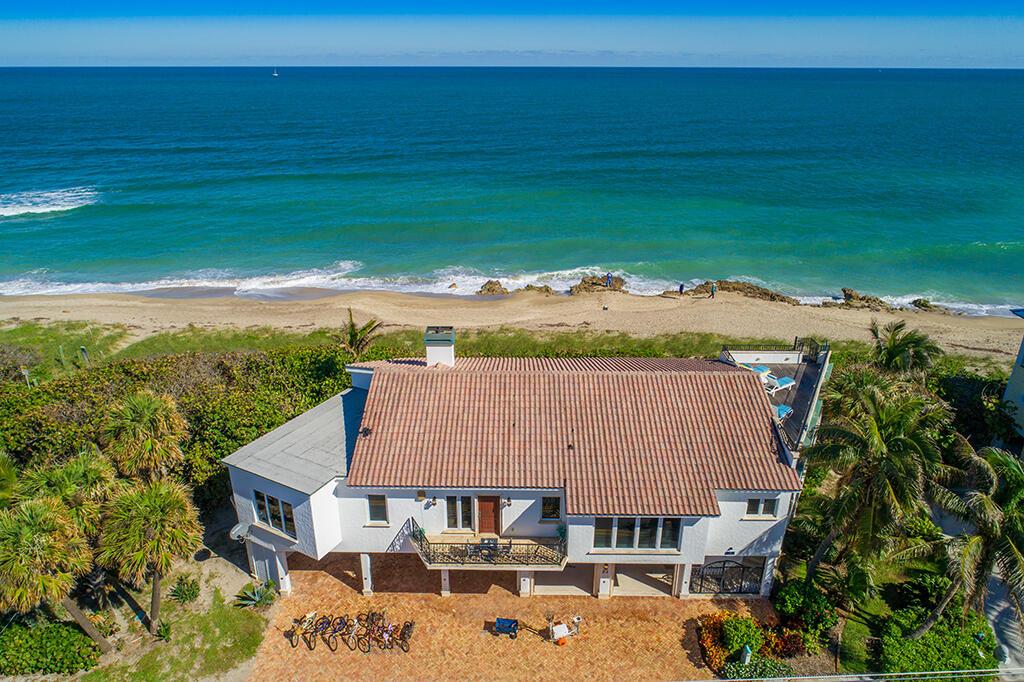 An aerial view of a white beach house with a tiled roof and brick driveway — 23 NE Macarthur Boulevard, Stuart FL 34996, STUART, FL