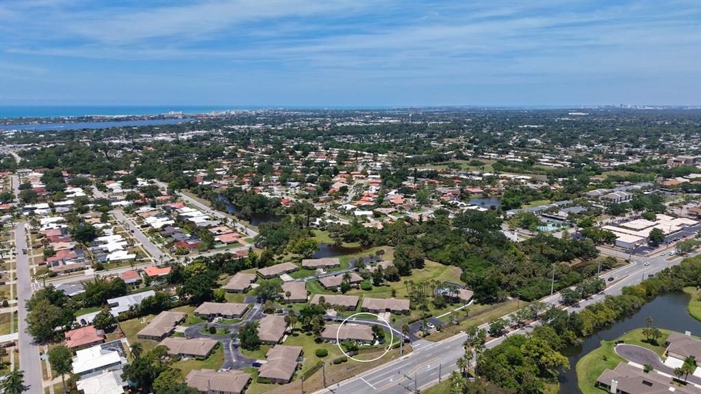 An aerial view shows a residential neighborhood with a circled single-story building near a road — 2902 CAPTIVA GARDENS DRIVE UNIT 3, SARASOTA, FL