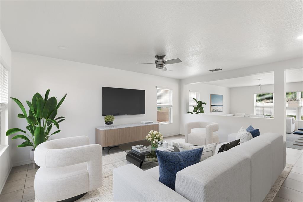 This living room features white walls, a television, a media console, and modern furniture — 11309 BRIGHTON KNOLL LOOP, RIVERVIEW, FL