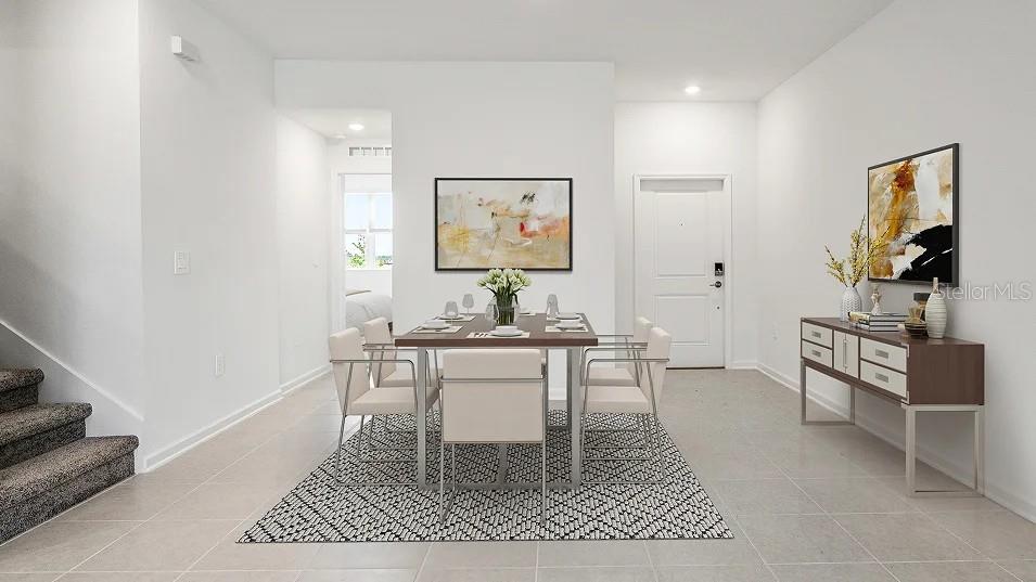 A dining area features a table with six chairs on a patterned rug near stairs — 5553 RONIN DRIVE, ST CLOUD, FL