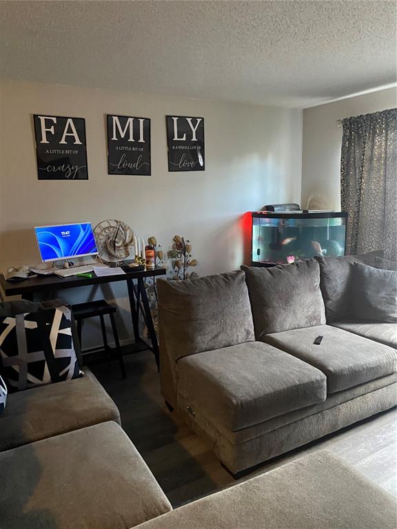 A living room features a grey sectional sofa, a desk with a computer, and an aquarium — 5520 20TH STREET, ZEPHYRHILLS, FL