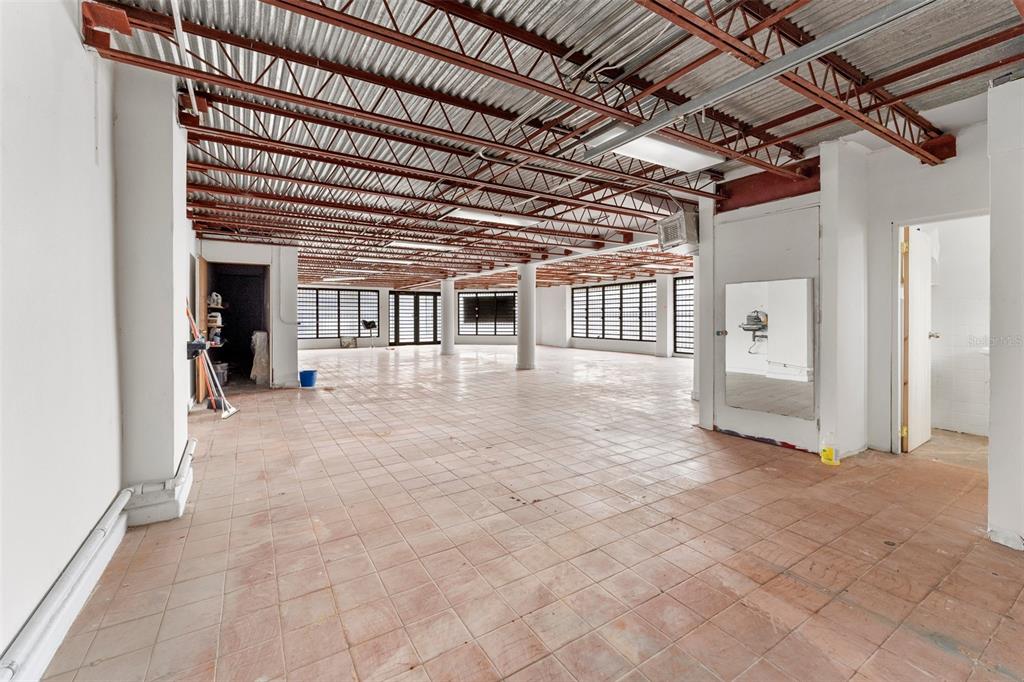 An open commercial space features a tiled floor, exposed metal ceiling, and large windows — 241 ELEANOR ROOSEVELT AVENUE, SAN JUAN, PR