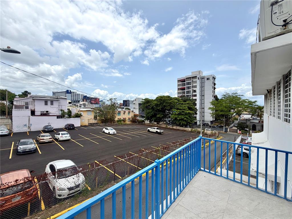 A view from a balcony overlooking a paved parking lot and surrounding city buildings — 1410 EDUARDO GEORGETTI, SAN JUAN, PR