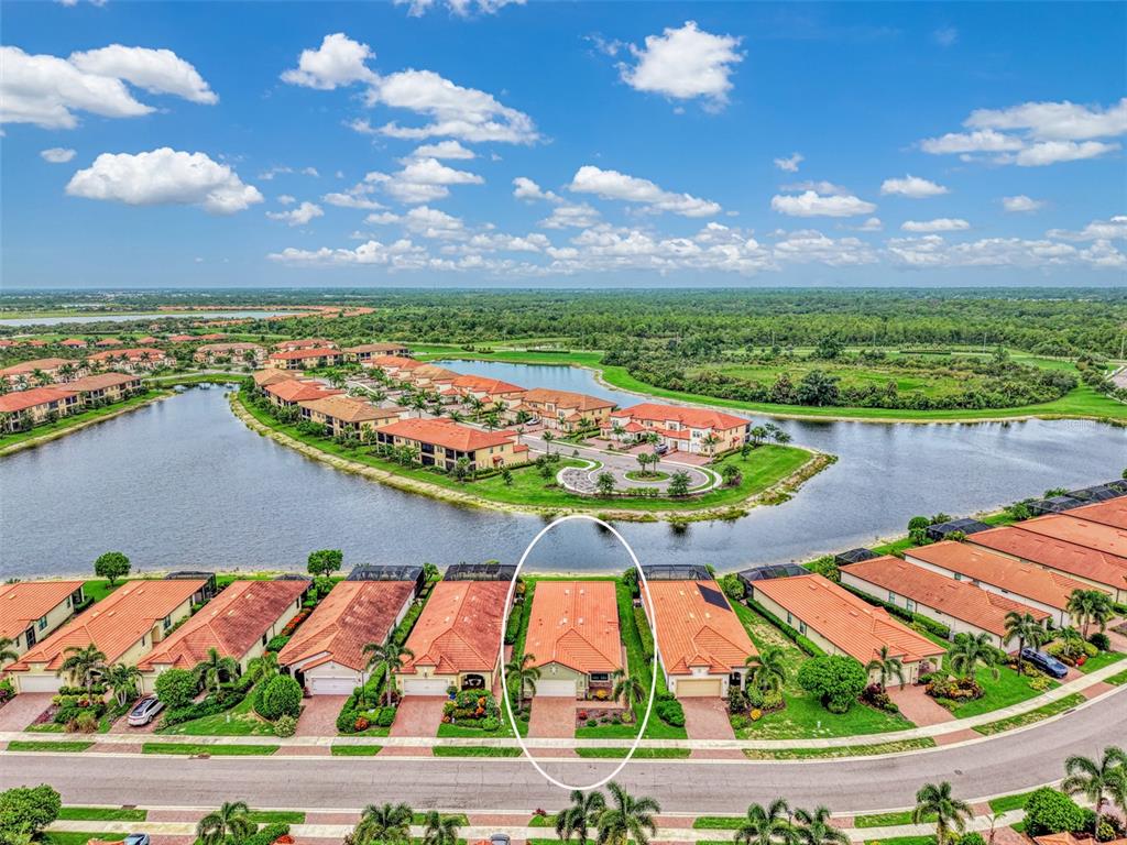 An aerial view shows a single-story residential home with a tile roof and attached garage — 10065 COZY GROVE DRIVE, VENICE, FL