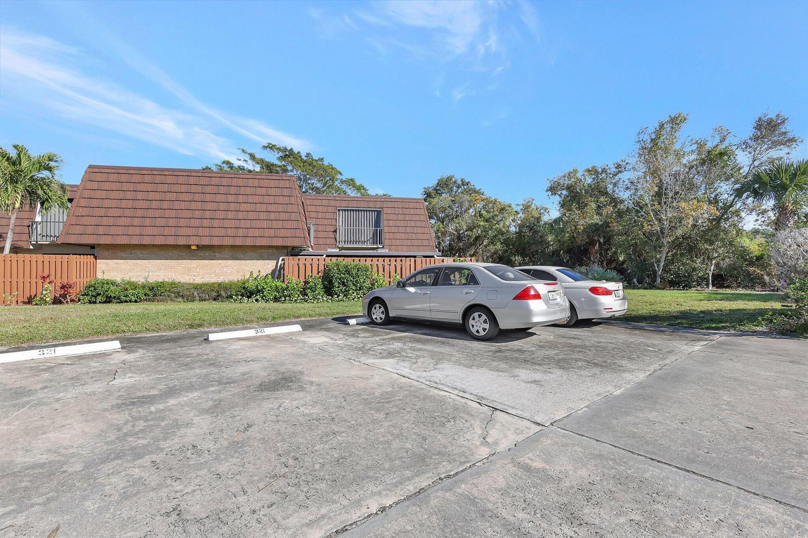 A silver sedan is parked in a concrete lot in front of a residential building — 5852 SE Riverboat Drive # 321, Stuart FL 34997, STUART, FL