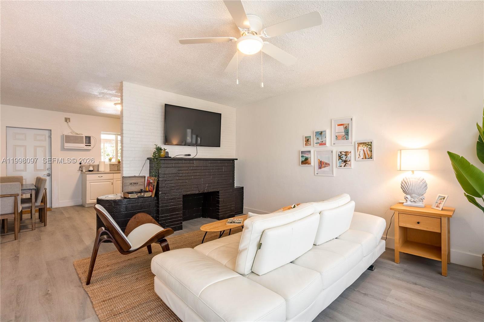 A patio features a dining table, fire pit, lounge seating, and a shade sail at night — 20 SE 13th Ter # 2, Dania Beach FL 33004, DANIA BEACH, FL