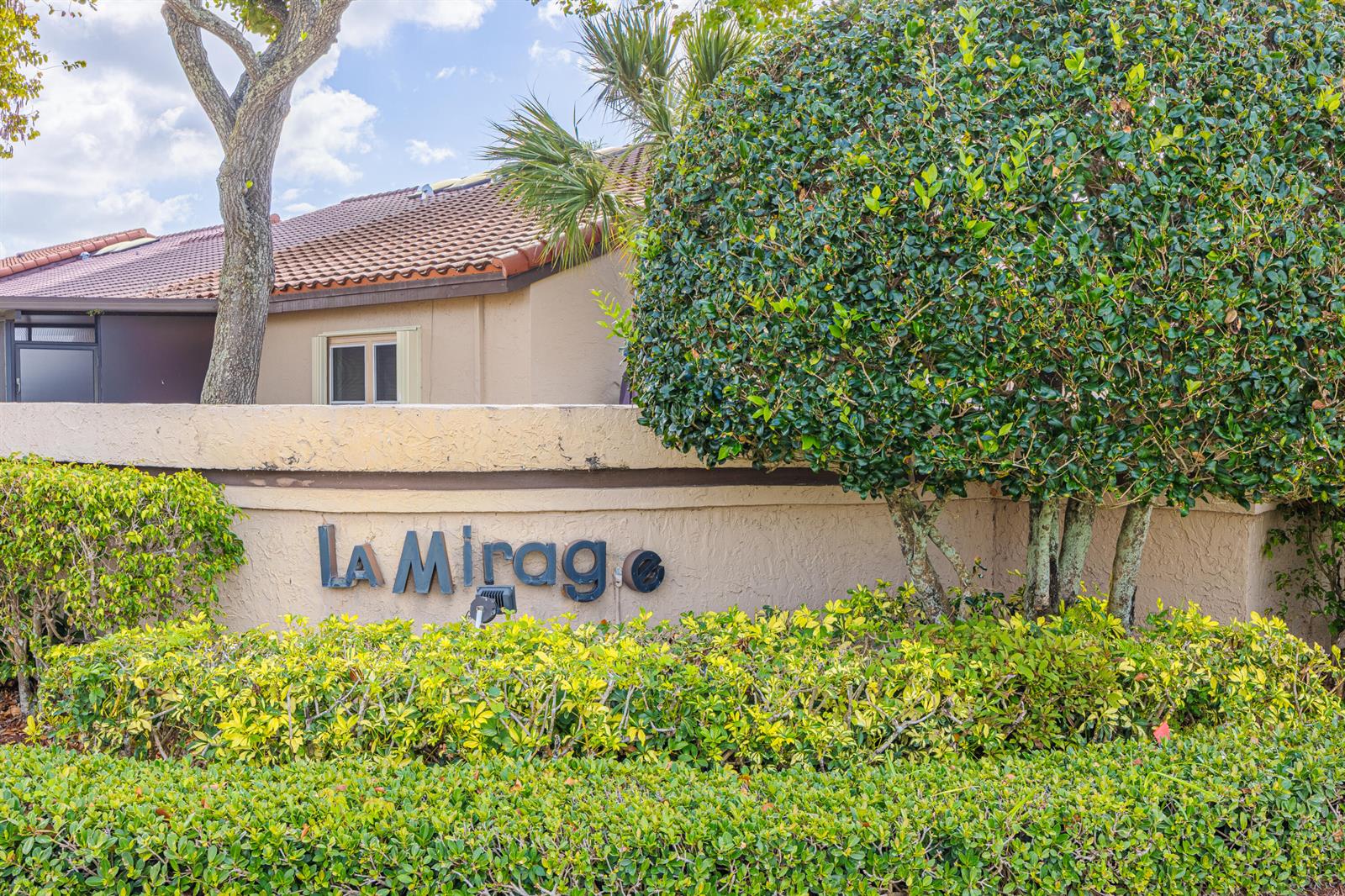 A sign reading La Mirage sits on a stucco wall in front of a building — 3625 Inverrary Boulevard W, Lauderhill FL 33319, LAUDERHILL, FL