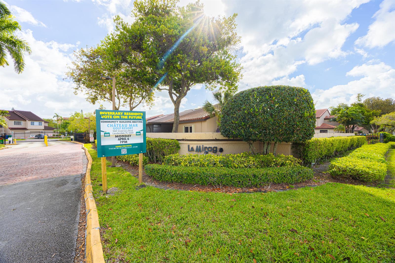 A sign for a community meeting stands in front of a landscaped entrance monument — 3625 Inverrary Boulevard W, Lauderhill FL 33319, LAUDERHILL, FL