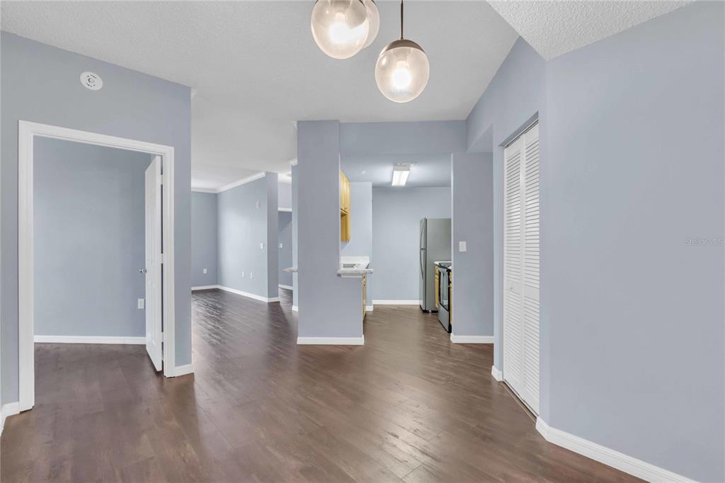 An interior view shows a kitchen with light wood cabinets and a dining area — 4763 TRAVINI CIRCLE UNIT 3-303, SARASOTA, FL