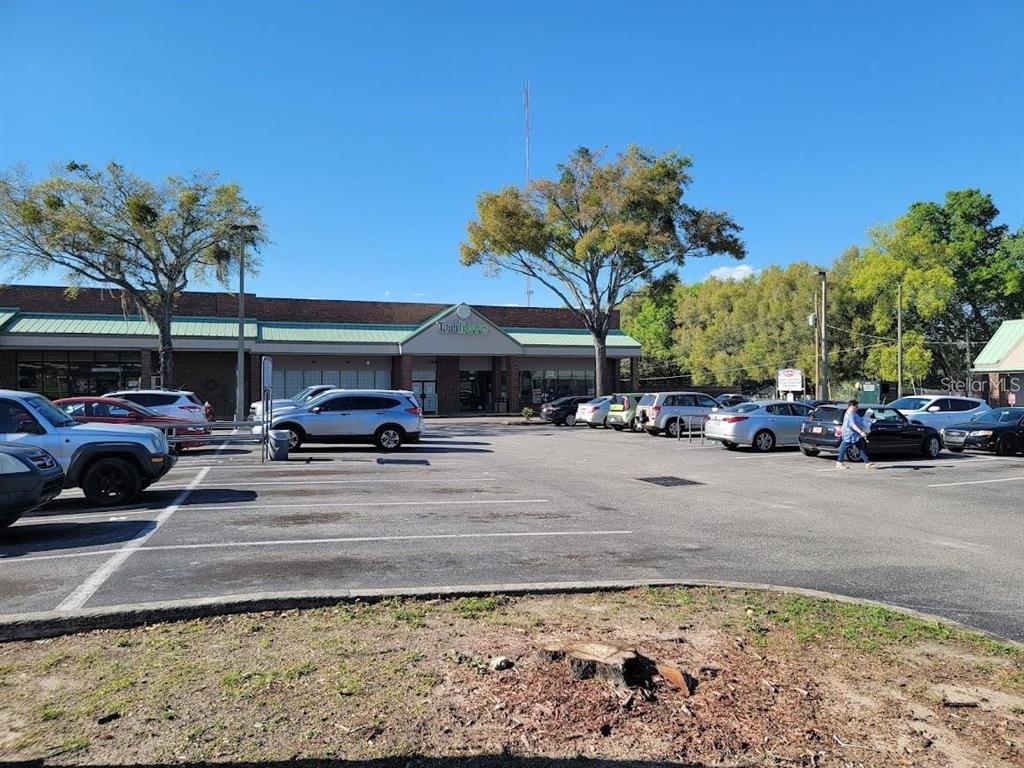 A parking lot in front of a commercial building with a Trulieve storefront — 1927 SW COLLEGE ROAD UNIT B, OCALA, FL
