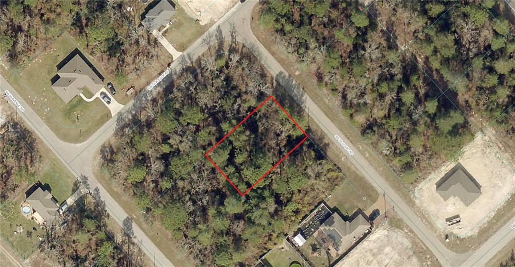 An aerial view shows a rectangular, wooded vacant lot outlined in red between two roads — SW 55TH COURT ROAD, OCALA, FL